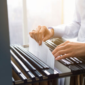 Office clerks hand filing document